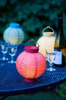 Coloured lanterns and glasses on a garden table