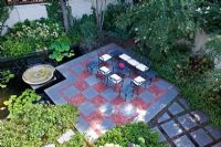 Seating area on checkerboard patio - The Knight Garden