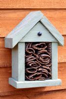 Homemade insect house with tree bark inside