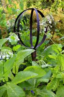 Nicotiana - Tobacco plants surrounding a metal sculpture