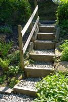 Garden steps made of wood and stone chippings with handrail