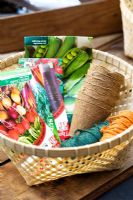 Basket filled with seedpackets, strings and biodegradable fibre pots
