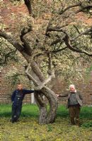 Christopher Lloyd and Fergus Garrett standing under Malus floribunda