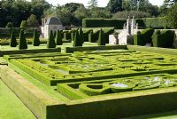 Looking down on the Great Garden at Pitmedden with colourful Buxus - Box -edged parterres infilled with annuals, Taxus baccata - Yew - pyramids and buttresses and on the western wall, an elegant stone pavilion and double staircase - The National Trust for Scotland