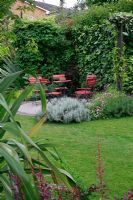 Marijke's garden. View across the lawn to the well screened circular patio