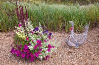 Ornaments Willow Goose and duck with pot packed with annuals at Wilkins Pleck (NGS) in late summer at Whitmore near Newcastle-under-Lyme in North Staffordshire
