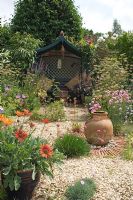 Arbour and urn as focal points in a gravel garden