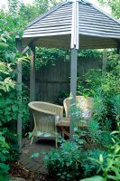 Garden chairs under covered patio with pergola