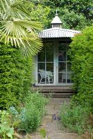 Colonial looking summerhouse framed by Taxus baccata and Trachycarpus fortunei - Montford Cottage, Lancashire