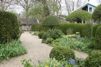 Gravel path and Spring borders - The Teagarden is a combination of model garden, garden shop and tearoom in Weesp, Holland.
