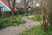 Gravel paths with Spring borders - The Teagarden is a combination of model garden, garden shop and tearoom in Weesp, Holland. 