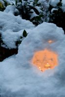 Tea light candles set in miniature snow grotto