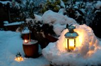 Tea light candle lantern set in miniature snow grotto, plus other lanterns