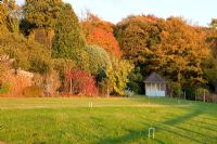 View accross lawn to summerhouse at Highfield Hollies, Hampshire, UK
