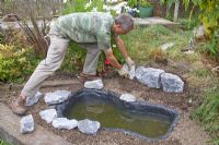 Garden pond project - step by step - adding edging stones to hide lining