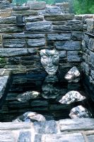 The Minder Ruin Garden with pool and sculpted stone faces by Marcia Donahue - Chanticleer Garden, Pennsylvania, USA 