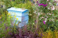 Beehive in flowerbed