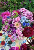 Colourful cut summer flowers in bucket on patchwork tablecloth - Dahlias, Zinnias, Mattiola incana, Nigella, Dianthus barbartus 
