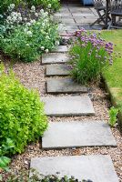 Stepping stones in gravel with herbs