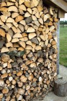 Firewood in dry storage ready for winter fuel