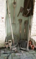 Old gardening tools in potting shed                        