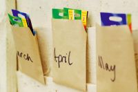Brown envelopes with days of the month written on them for storing seeds
