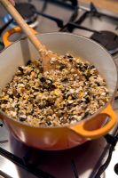 Heating ingredients in a pan to make seed cakes for wild birds