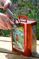 Making a recycled container from olive oil tin