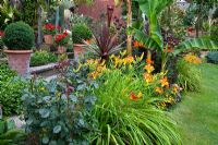 Exotic garden with Musa, Hemerocallis 'Frans Hals and Cordyline australis 