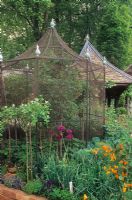 Raspberries inside bird protection cage in ornamental kicthen garden