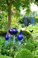 Cottage garden with metallic ornaments