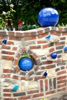 Curvy wall with nooks and ball ornaments