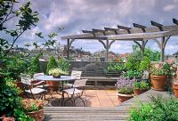 Roof garden with wooden pergola, terracotta containers and furniture - Amsterdam, Holland 