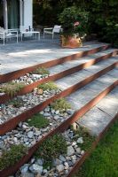 Corten steel and stone stairs with Thymus- Thyme growing in chippings