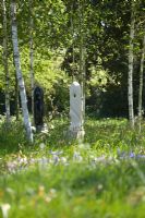Modern sculpture designed by Mark Humphrey underneath Betula - Birch trees in meadow at Hatfield House garden, May 2008, UK
