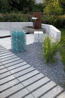 Modern garden with fountain, glass gabion and granite stone
