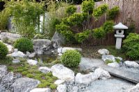 Japanese garden with granite path, pond, lantern, Taxus - Yew topiary and Buxus spheres