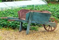 Old wooden wheelbarrow in the vegetable garden