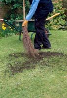 Autumn lawn care - Top dress the lawn by spreading a sandy loam mixture in dollops at 3lb square metre all over the surface. Brush the dressing lightly into the turf to fill holes and gaps, using the back of a rake or besom broom