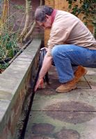 Watering supply kit - If you are building a patio, a good tip is to leave a gully between a wall and the paving to keep pipes hidden from view, while giving easy access to the water supply