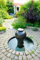Moroccan Style water feature set in circular paving with mosaic lined pool