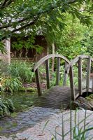 Wooden bridge over pond in Japanese Garden. Barnsdale Garden
