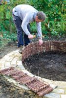 Mini potager - Step 6. Use short woven panels to form a low edging along the brick path
