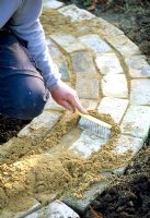Mini potager - Step 5.  Brush sand into the gaps between the bricks