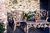 Rustic seats and table outside the Garden cottage - Plas Cadnant, Menai Bridge, Anglesey, Wales