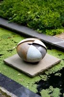 Stoneware sculpture by Gordon Cooke on pond