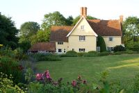 House seen through herbaceous borders, June - Heveningham, Suffolk