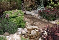 Natural effect pond created with drift wood, rope, pebbles and plants including Sedum and Lavandula. Southport Flower Show 2010