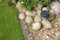 Solar powered garden light in cobble and gravel bed edged by stone setts - 'Trevinia', Stubbins, Lancashire, NGS