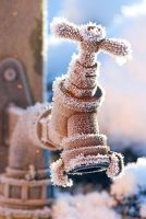 Portrait of a frozen outside garden tap in the winter
